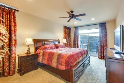 a bedroom with a bed and a window at Spacious Granby Home with Views Less Than 2 Mi to Ski and Golf in Granby