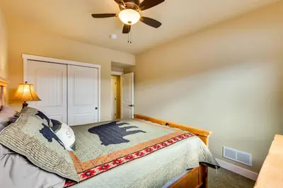 a bedroom with a bed with a ceiling fan at Spacious Granby Home with Views Less Than 2 Mi to Ski and Golf in Granby