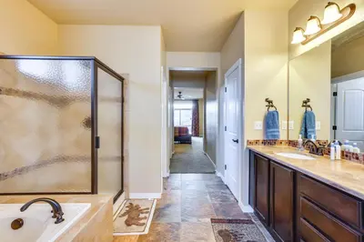 a bathroom with two sinks and a shower at Spacious Granby Home with Views Less Than 2 Mi to Ski and Golf in Granby