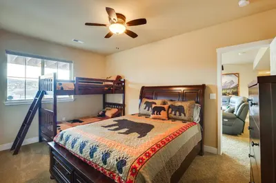 a bedroom with a bed and a ceiling fan at Spacious Granby Home with Views Less Than 2 Mi to Ski and Golf in Granby