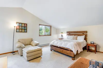 a bedroom with a bed and a couch and a chair at Mountain Vistas in Silverthorne