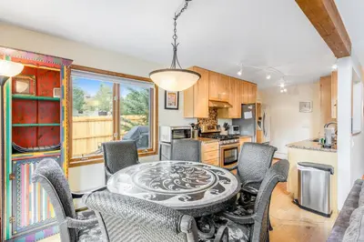 a kitchen with a dining room table and chairs at Mountain Vistas in Silverthorne