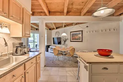 a kitchen with a table and a dining room at Ski Shuttle and Pool Modern Silverthorne Condo! in Silverthorne