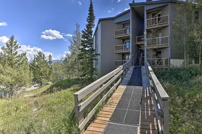 a house with a boardwalk leading up to a building at Ski Shuttle and Pool Modern Silverthorne Condo! in Silverthorne