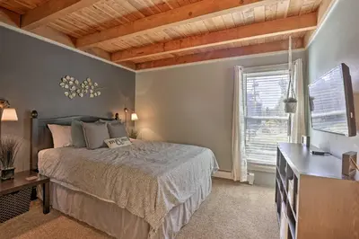 a bedroom with a bed and a dresser and a window at Ski Shuttle and Pool Modern Silverthorne Condo! in Silverthorne