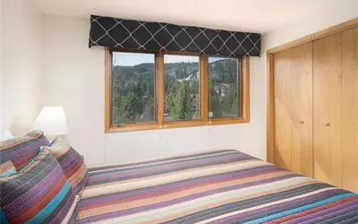 a bedroom with a bed and a window at Frostfire D24 condo in Keystone