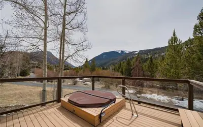 a bed on a deck with a view of the mountains at Frostfire D24 condo in Keystone