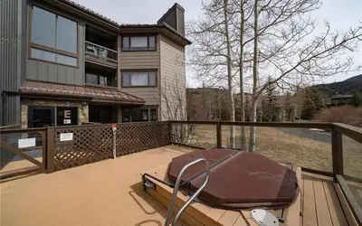 a house with a deck with a boat on it at Frostfire D24 condo in Keystone