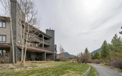 a large building with a yard next to a road at Frostfire D24 condo in Keystone
