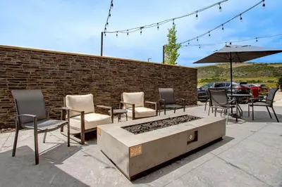 a patio with chairs and a table and an umbrella at Fairfield by Marriott Inn & Suites Denver Southwest, Littleton in Littleton