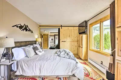 a bedroom with a large bed and a window at Keystone Mountain Getaway Walk to Ski Lifts in Keystone