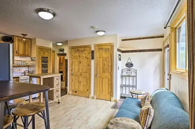 a living room with a blue couch and a table at Keystone Mountain Getaway Walk to Ski Lifts in Keystone