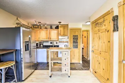a kitchen with wooden cabinets and a stainless steel refrigerator at Keystone Mountain Getaway Walk to Ski Lifts in Keystone