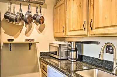 a kitchen with wooden cabinets and pots and pans at Keystone Mountain Getaway Walk to Ski Lifts in Keystone