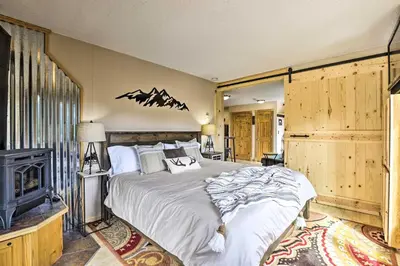 a bedroom with a large bed and a fireplace at Keystone Mountain Getaway Walk to Ski Lifts in Keystone