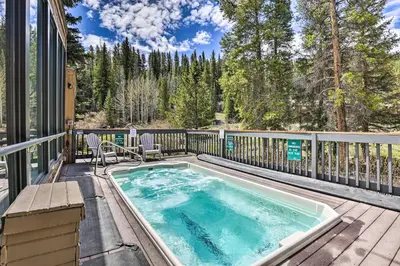 a hot tub on a balcony with a deck with chairs at Keystone Mountain Getaway Walk to Ski Lifts in Keystone