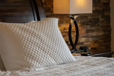 a bed with a pillow and a lamp on a table at Cozens Pointe I-101 condo in Fraser