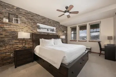 a bedroom with a bed and a brick wall at Cozens Pointe I-101 condo in Fraser