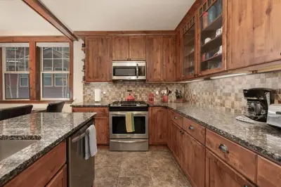 a kitchen with wooden cabinets and a stove top oven at Cozens Pointe I-101 condo in Fraser