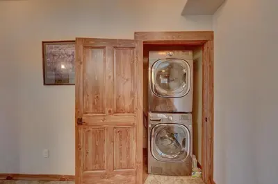 a laundry room with a washer and dryer next to a door at Cozens Pointe I-101 condo in Fraser