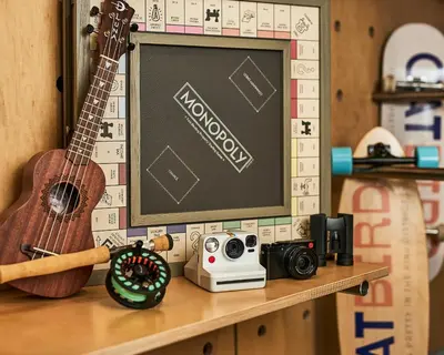 a guitar and a camera on a shelf at Catbird Hotel in Denver