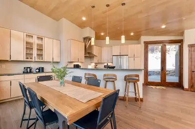 a kitchen and dining room with a wooden table and chairs at Azure Vista Vacation Home at Windcliff home in Estes Park