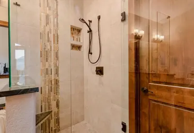 a shower with a glass door in a bathroom at Azure Vista Vacation Home at Windcliff home in Estes Park