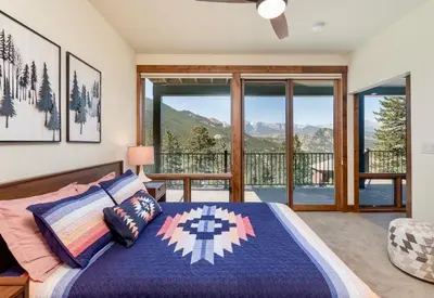 a bedroom with a bed and a balcony with a view at Azure Vista Vacation Home at Windcliff home in Estes Park