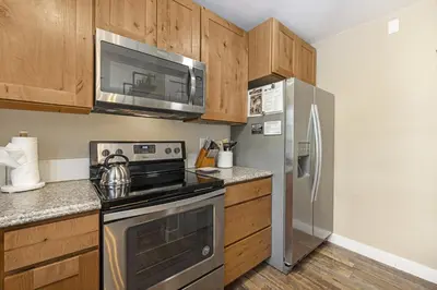 a kitchen with a stove and a refrigerator at Serenity in the Rockies townhouse in Estes Park