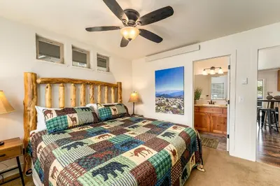 a bedroom with a bed and a ceiling fan at Serenity in the Rockies townhouse in Estes Park