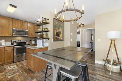 a kitchen and dining room with a table and chairs at Serenity in the Rockies townhouse in Estes Park