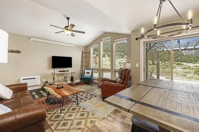 a living room with a couch and a table at Serenity in the Rockies townhouse in Estes Park