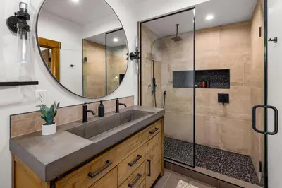 a bathroom with a sink and a mirror at Private Lakefront Cabin - Two Large Patios, Jacuzzi, Indoor/Outdoor Fireplace in Estes Park