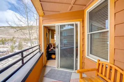a balcony with a sliding glass door on a house at Ski-InandOut Condo with Hot Tub Access in Keystone! in Keystone