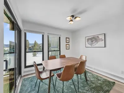 a dining room with a table and chairs and windows at A304 Lake Cliffe condo in Dillon