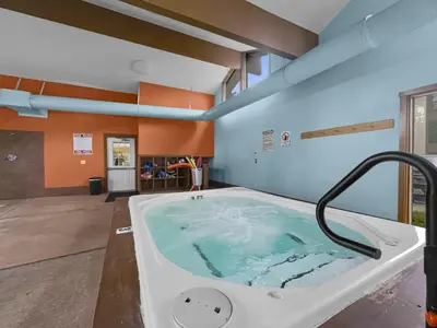 a jacuzzi tub in a room with orange walls at A304 Lake Cliffe condo in Dillon