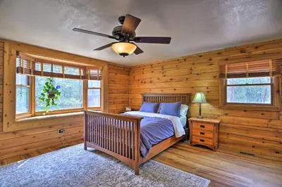 a bedroom with a bed and a ceiling fan at The Pinecone Palace with Hiking Trail Access! in Lyons
