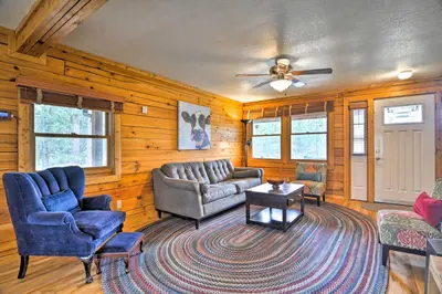 a living room with a couch and chairs and a table at The Pinecone Palace with Hiking Trail Access! in Lyons