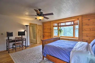 a bedroom with a bed and a ceiling fan at The Pinecone Palace with Hiking Trail Access! in Lyons