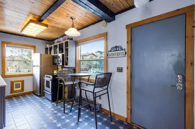 a kitchen with a table and chairs and a refrigerator at Sunshine & Snowfall in Silverthorne