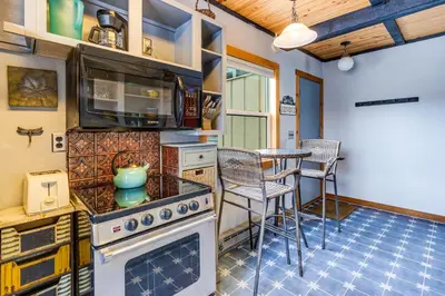 a kitchen with a stove and a table with chairs at Sunshine & Snowfall in Silverthorne