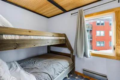 a bunk bed in a room with a window at Sunshine & Snowfall in Silverthorne