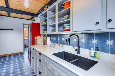 a kitchen with a sink and a red refrigerator at Sunshine & Snowfall in Silverthorne