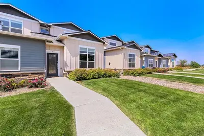a row of houses with a grass yard at Gorgeous Townhome Steps from the Brewery District! in Fort Collins