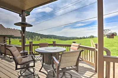 a patio with a table and chairs on a deck at On-Site Hiking Access Mtn-View Conifer Cabin in Conifer