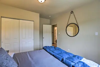 a bedroom with a blue bed and a mirror at On-Site Hiking Access Mtn-View Conifer Cabin in Conifer