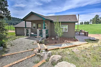 a small house with a garden in front of it at On-Site Hiking Access Mtn-View Conifer Cabin in Conifer