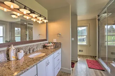 a bathroom with a sink and a large mirror at On-Site Hiking Access Mtn-View Conifer Cabin in Conifer