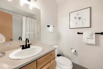 a white bathroom with a sink and a toilet at Hip Old Town North Gem! Near Breweries and River! in Fort Collins