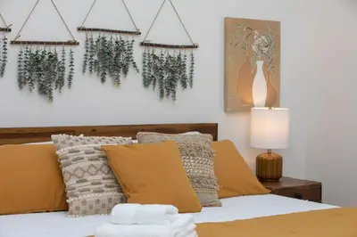 a bedroom with a bed with plants on the wall at Hip Old Town North Gem! Near Breweries and River! in Fort Collins